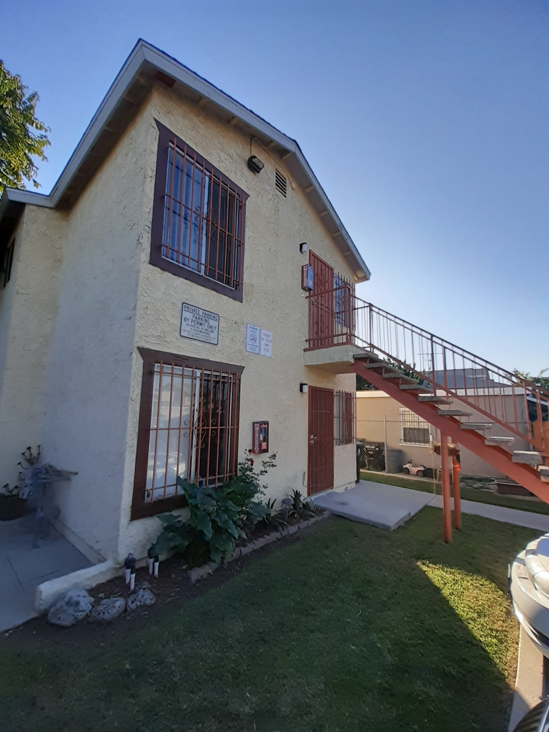 A house with a red door and a balcony.